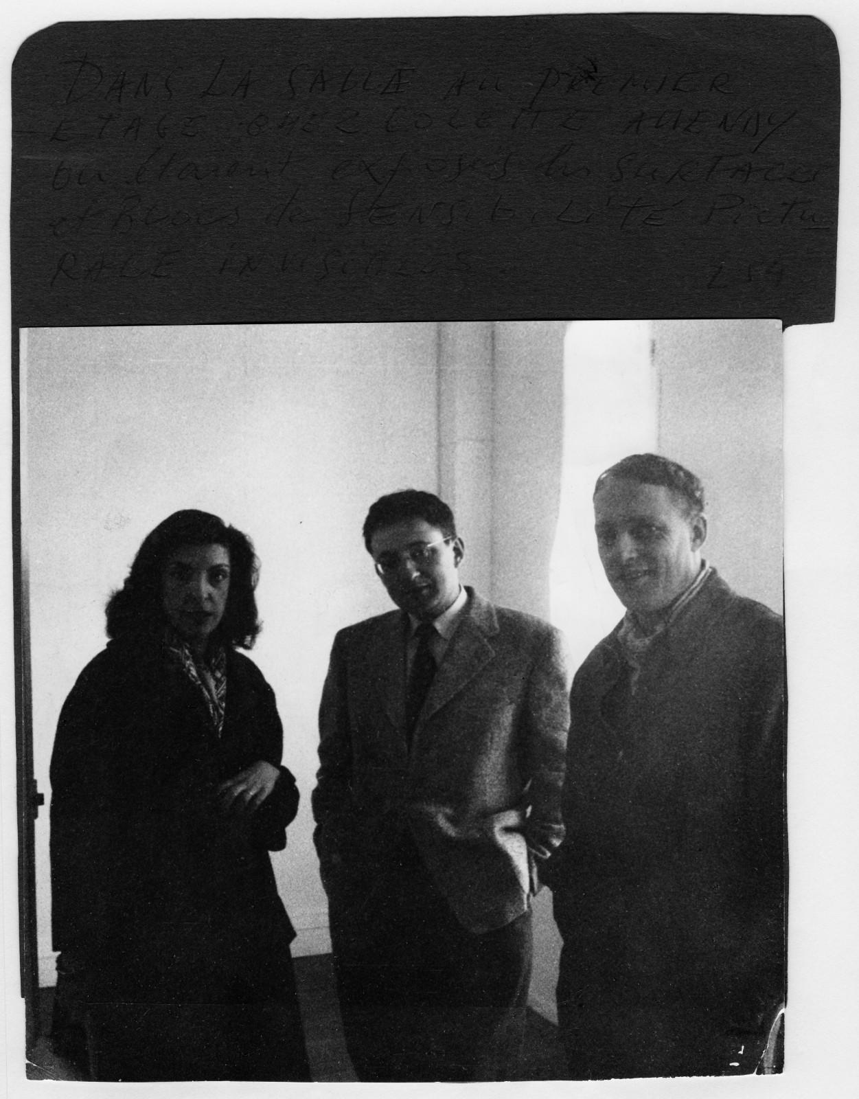 Iris Clert, Guy Debord, Asger Jorn during the opening of the exhibition of the exhibition "Yves Klein : Propositions monochromes", Colette Allendy Gallery, Paris, 1957