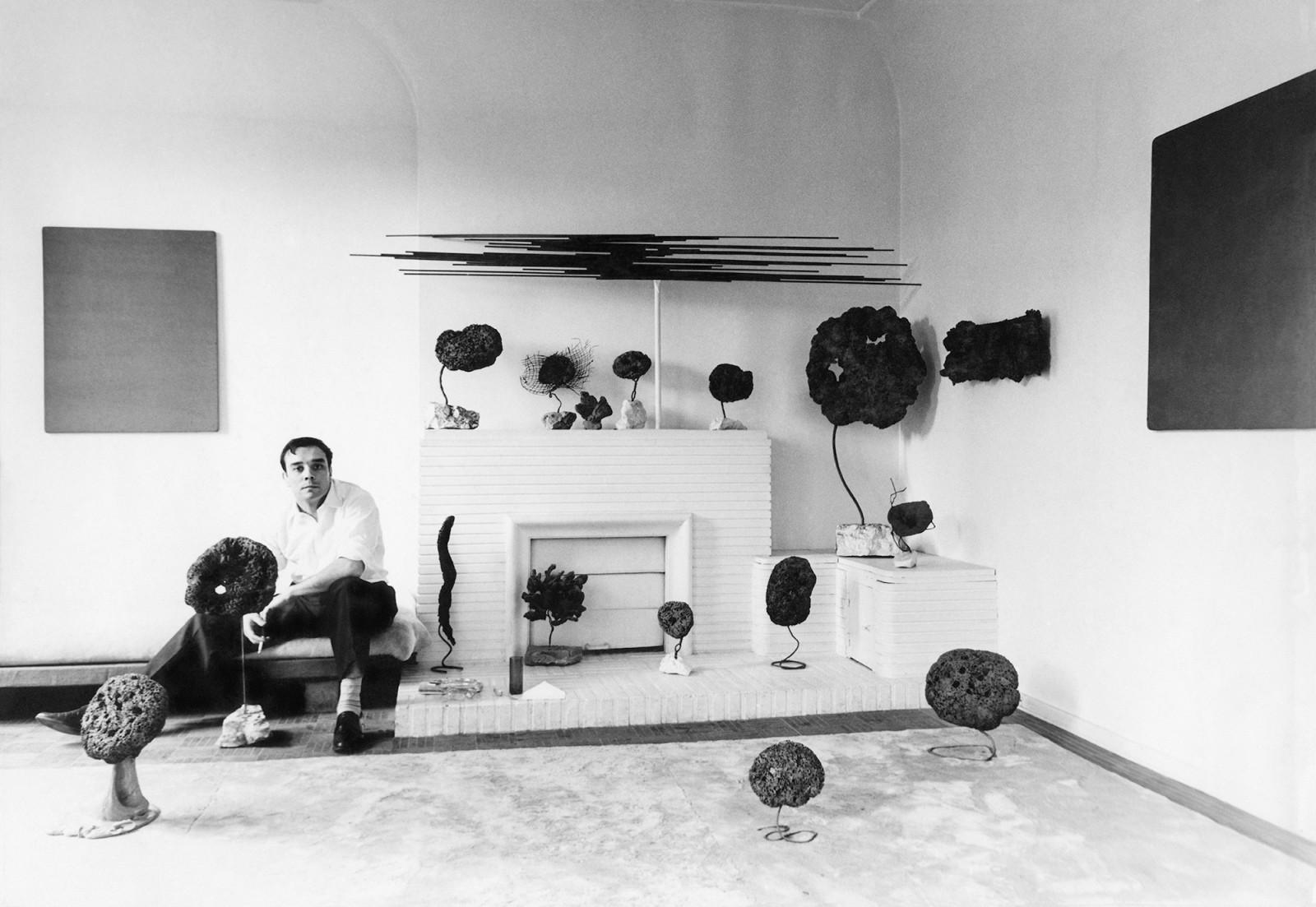 Yves Klein in his studio surrounded by his Sponge Sculptures