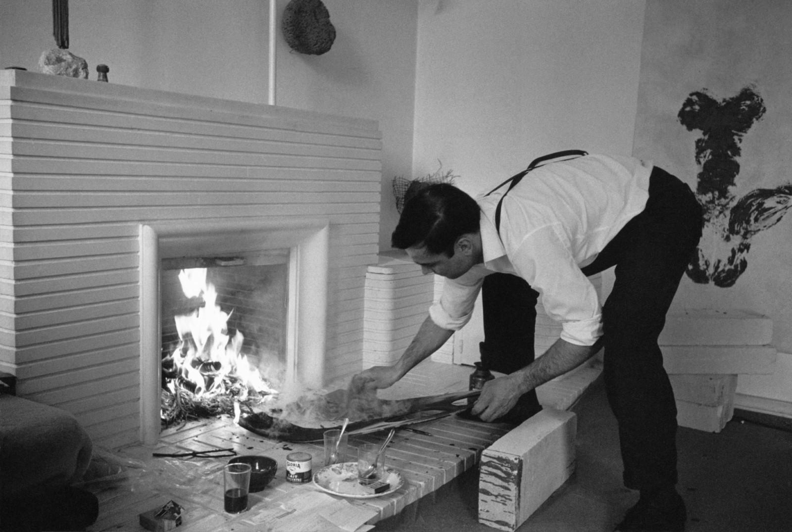 Yves Klein realizing a Fire Painting (F 136)