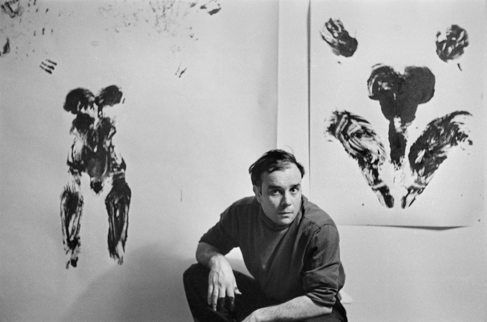 Yves Klein in front of his Anthropometries (ANT 50, ANT 54)