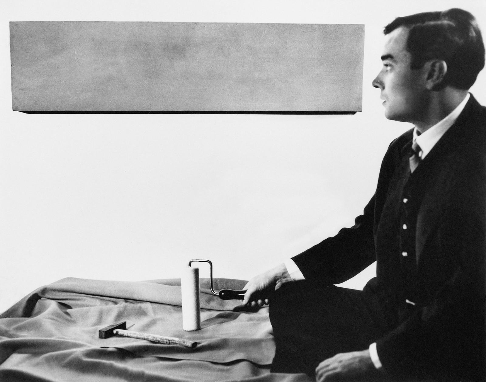 Yves Klein in front of one of his Monochromes in his studio