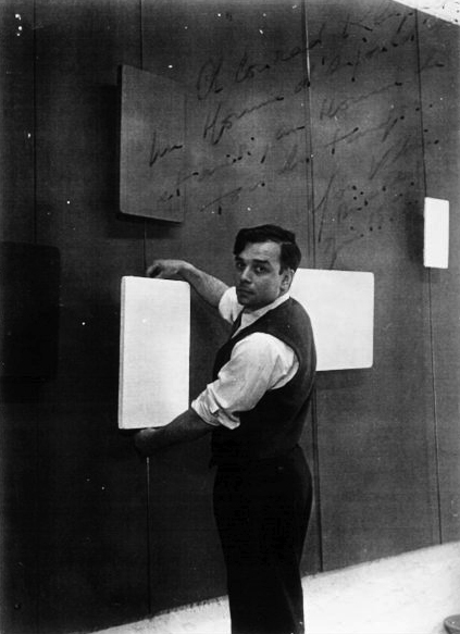 Yves Klein hanging his works for the exhibition "Yves Propositions monochromes", Galerie Schmela