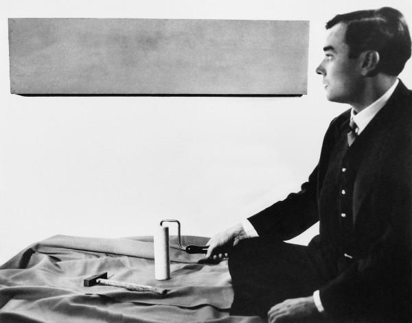 Yves Klein in front of one of his Monochromes in his studio